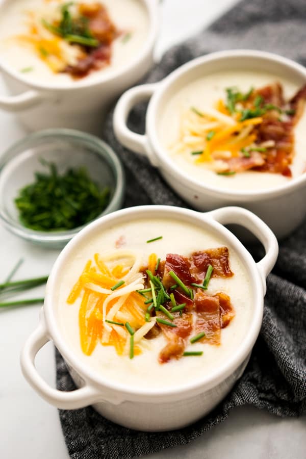 Bowls of potato soup with bacon and cheese