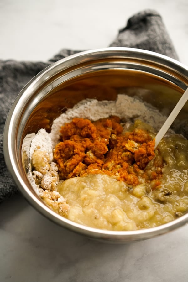 Maxing pumpkin banana mixture in a bowl