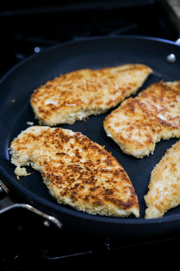 Pan frying breaded chicken parmesan