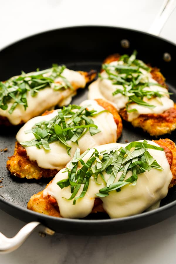 Chicken parmsan pieces in a skillet