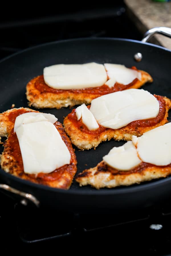 Top Chicken cutlets with red sauce and then mozzarella