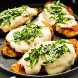 Breaded chicken topped with red sauce and melted cheese