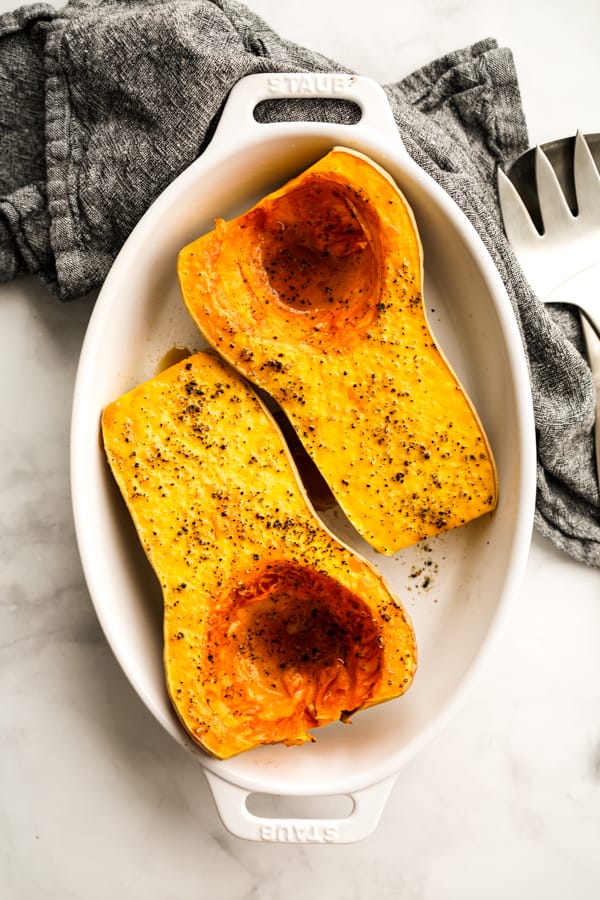 Top down view of two halves of a whole oven baked butternut squash