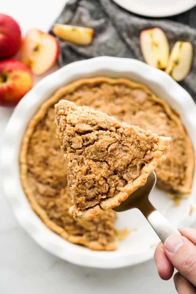 Top down view of a slice of apple crumble pie