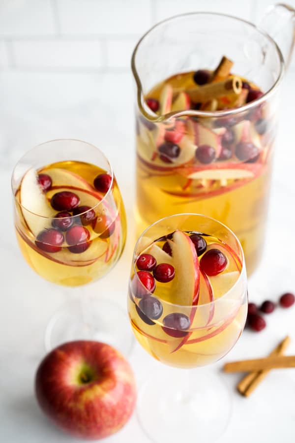 A jug and two glasses of apple cider sangria