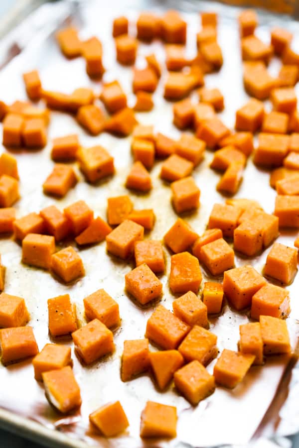 Cubed butternut squash on a baking sheet