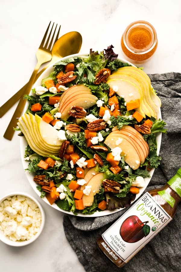 Fall Harvest Salad with bottle of vinaigrette on the side