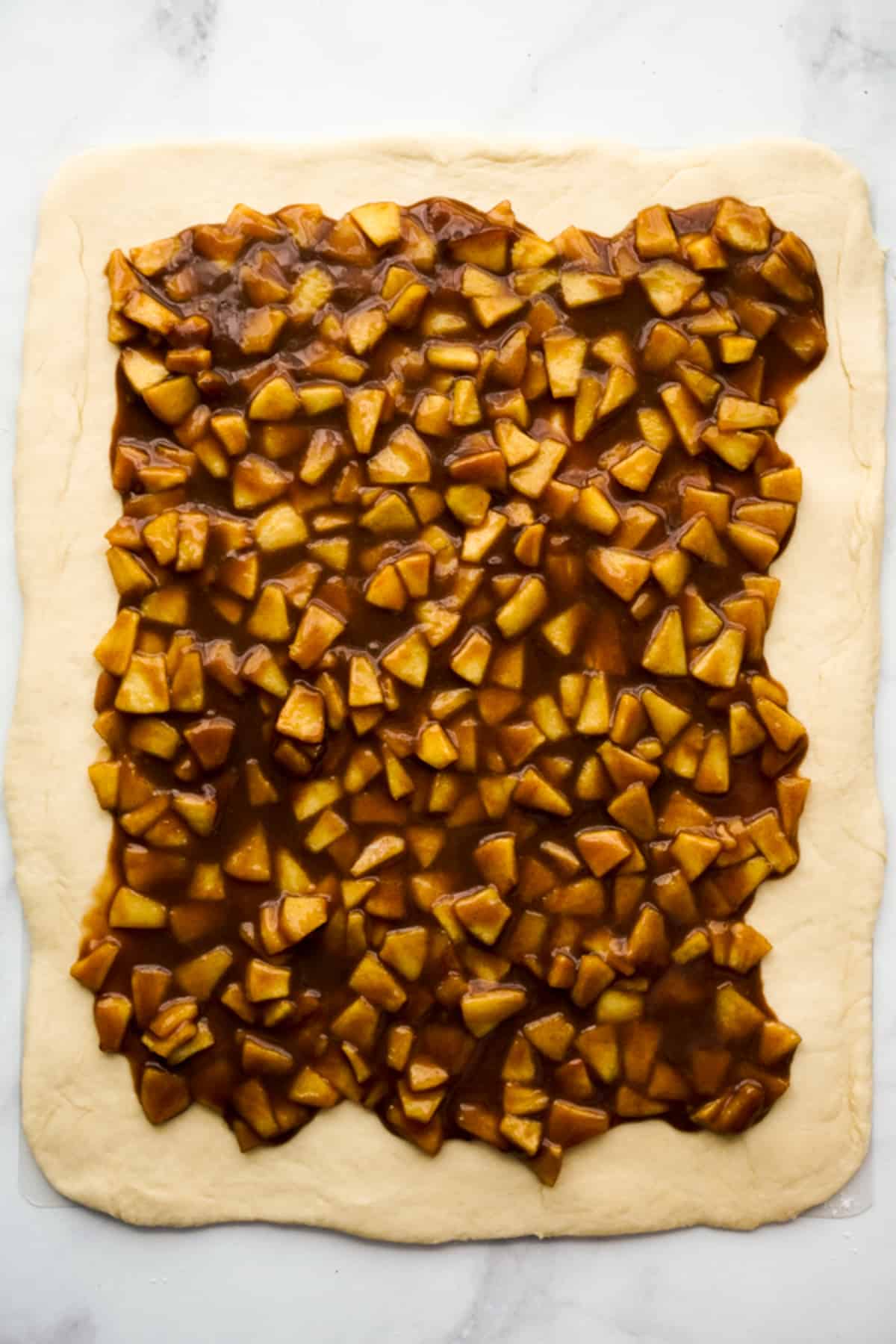Apple pie filling on a flattened dough