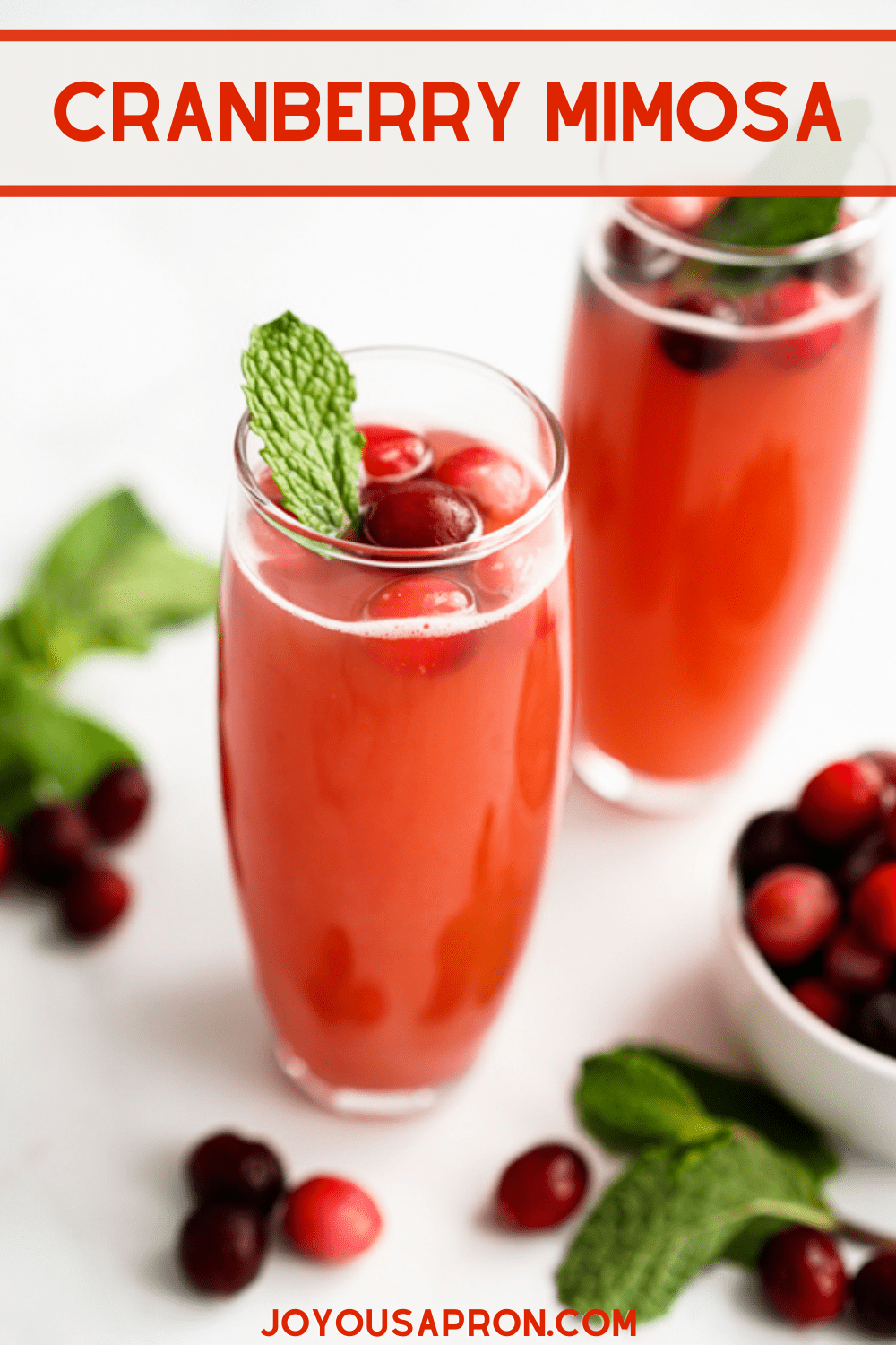 Cranberry Mimosa - Mimosa cocktail with a festive twist! This cranberry mimosa is a fizzy and delicious alcoholic drink perfect for the holidays! via @joyousapron