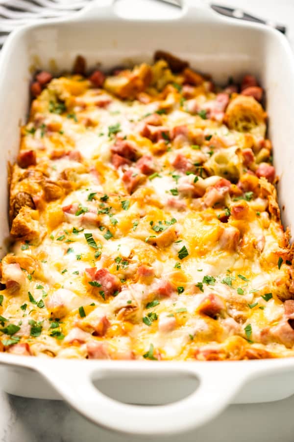 Croissant bake in a rectangular casserole topped with cheese and ham