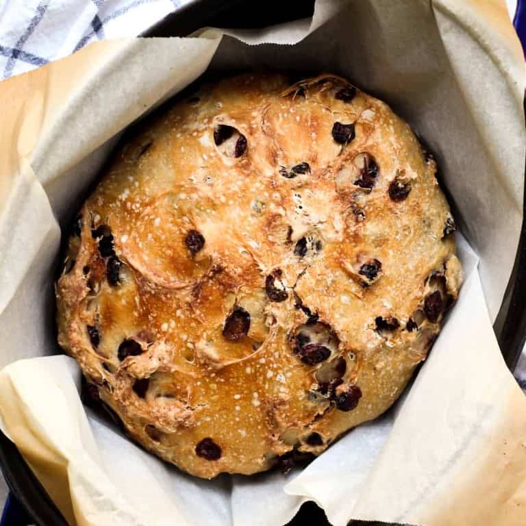 Crusty bread with dried cranberries in dutch oven
