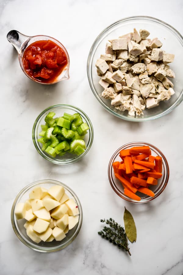 Ingredients for turkey stew: leftover turkey, carrots, celery, potatoes, tomatoes, herbs