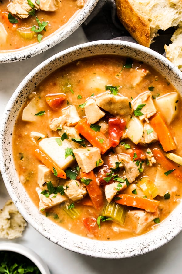 Close up of a bowl of chunky stew with turkey and veggies
