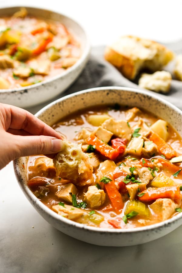 Dunking crusty bread into stew