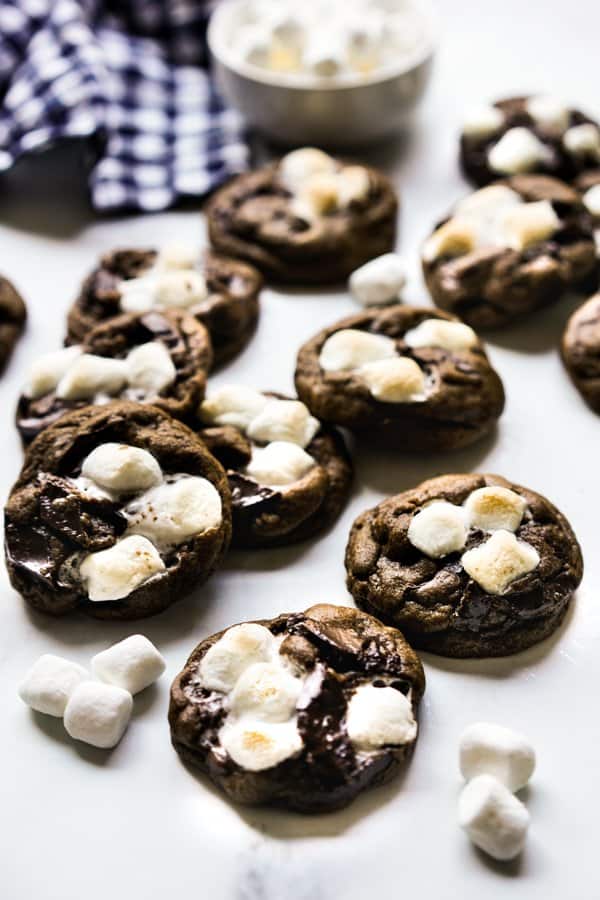 A bunch of Chocolate Marshmallow Cookies  with a bowl of marshmallow in the background