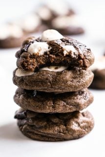 A stack of chocolate cookies with marshmallows on top