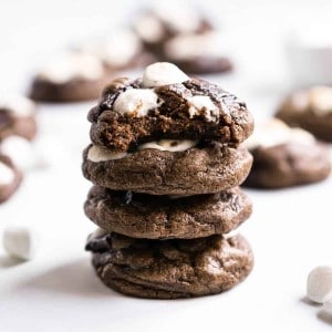 A stack of chocolate cookies with marshmallows on top