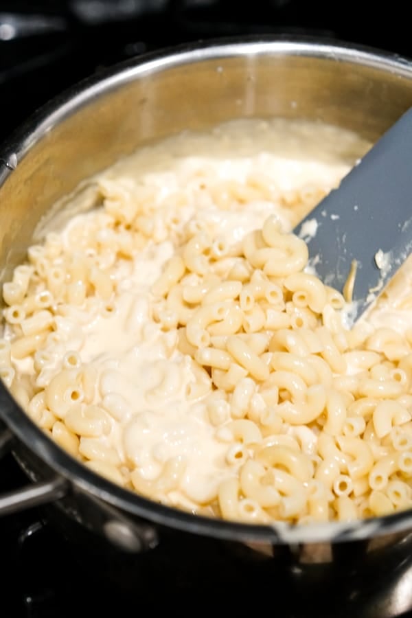 Adding pasta into the cheese sauce