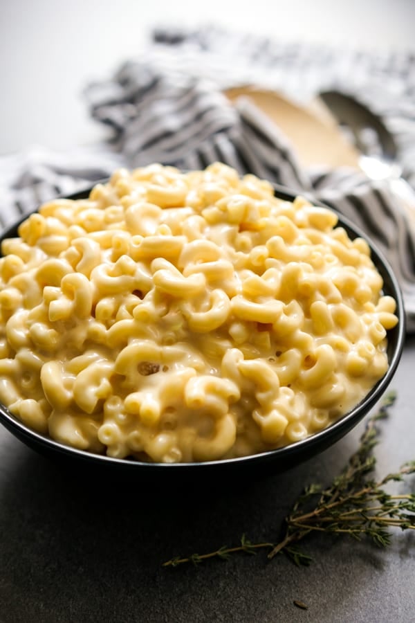 A black bowl piled with smoked gouda mac and cheese