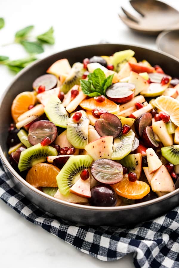 A colorful bowl of fruits tossed together 