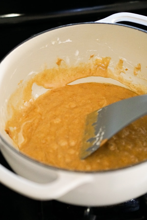 Making peanut butter marshmallow sauce in a pot