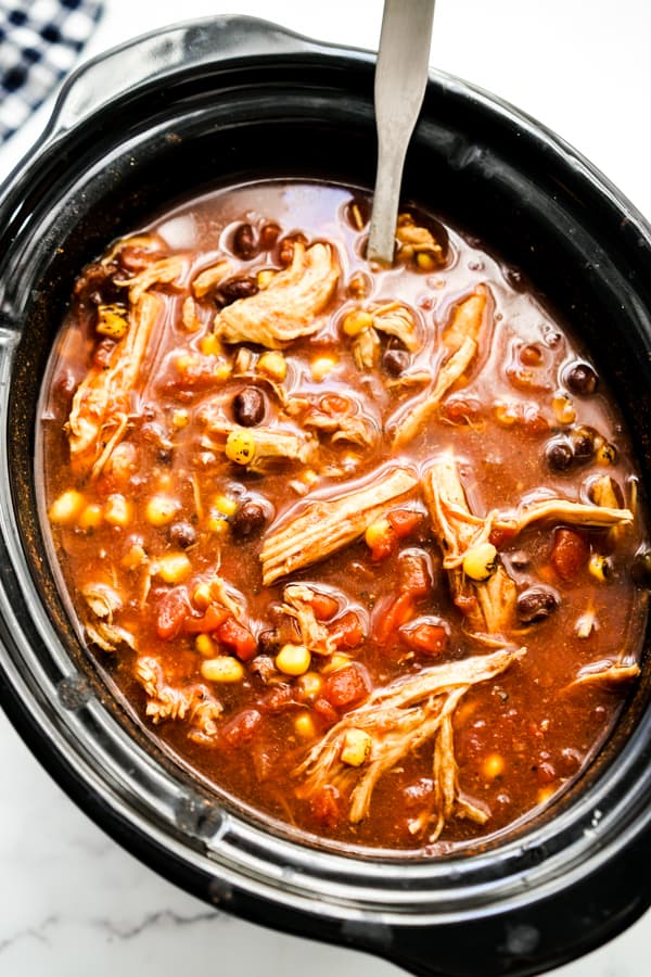 Chicken Taco Soup with shredded chicken in the crockpot