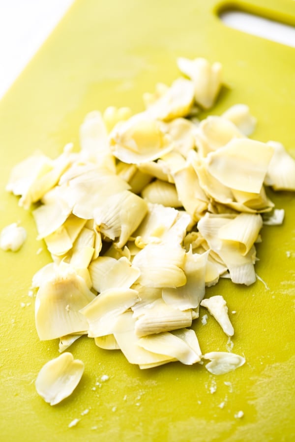 Peeled artichokes on a chopping board