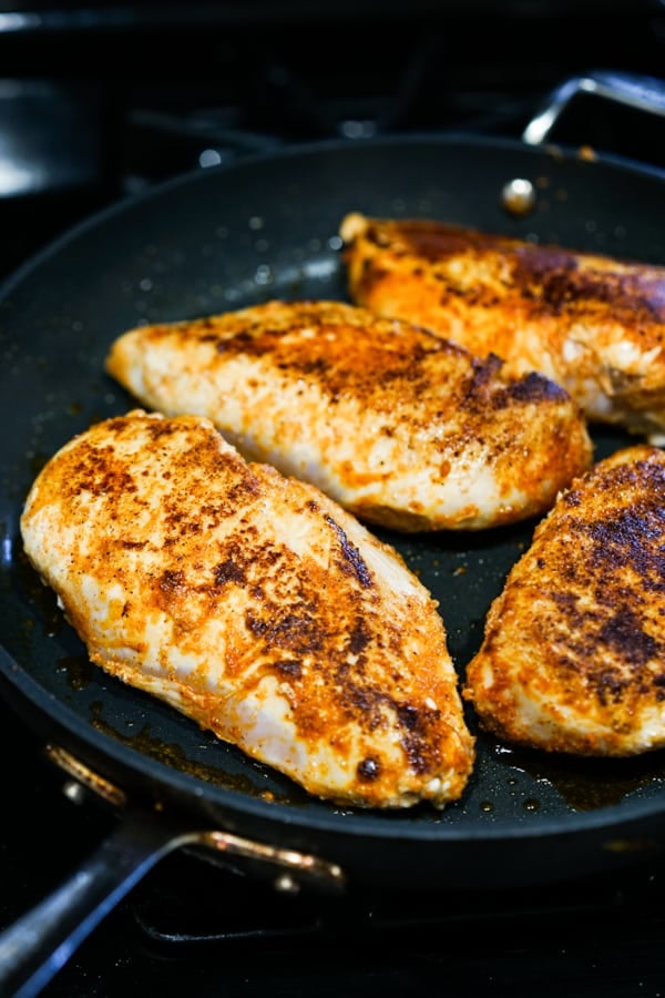 Pan frying chicken breast on skillet