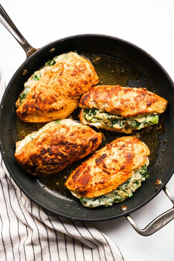 Spinach Artichoke Stuffed Chicken on a round non-stick skillet