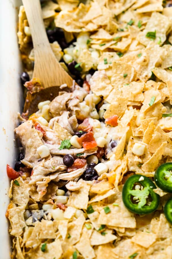 A closeup of creamy chicken casserole topped with tortilla chips