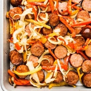 Sausage, red and orange peppers and onions on a pan