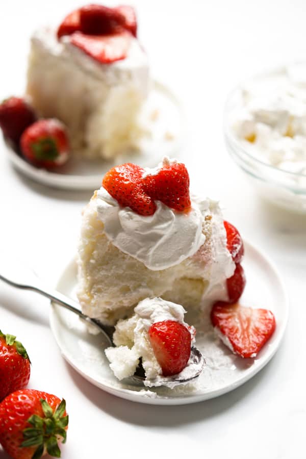 Two tiny plates of two slices of Strawberry Shortcake Angel Food Cake