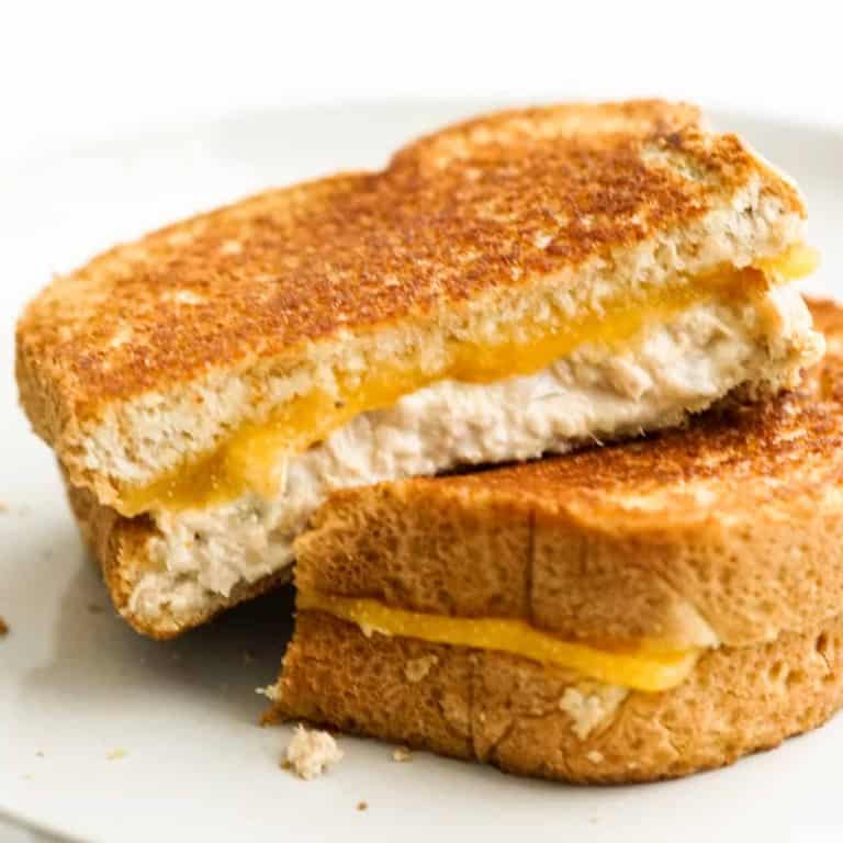 Two slices of grilled cheese tuna melt on a plate