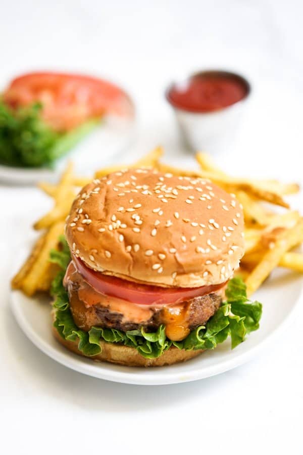 Cheddar Cheese Stuffed Burger with fries in the background