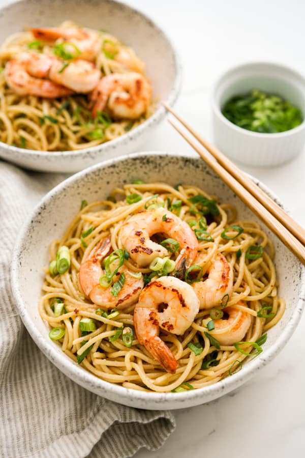 Two bowls of garlic noodles with shrimp