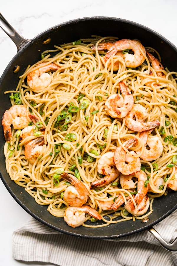 Asian Garlic Noodles with shrimp and green onions in a large skillet