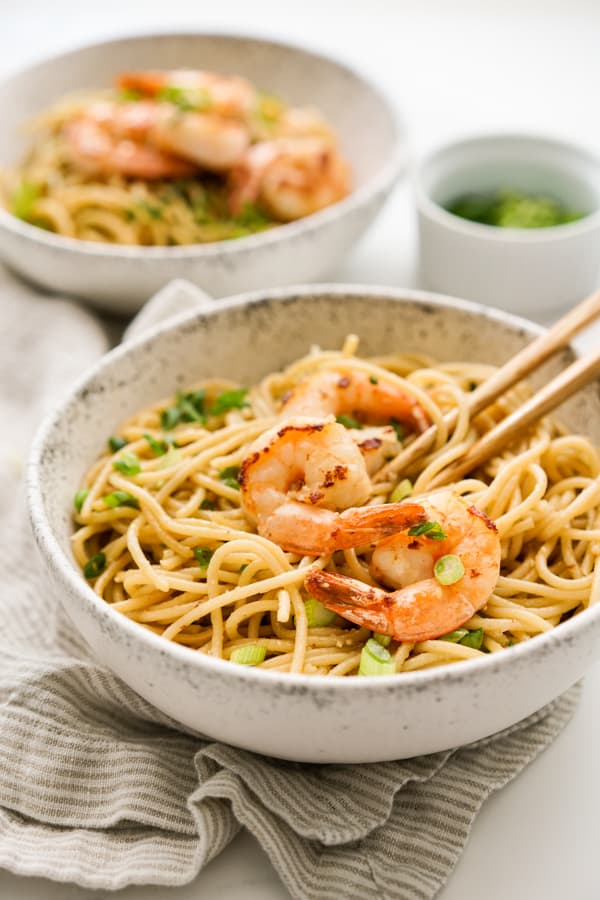 Two bowls of Shrimp Garlic Noodles with chopsticks 