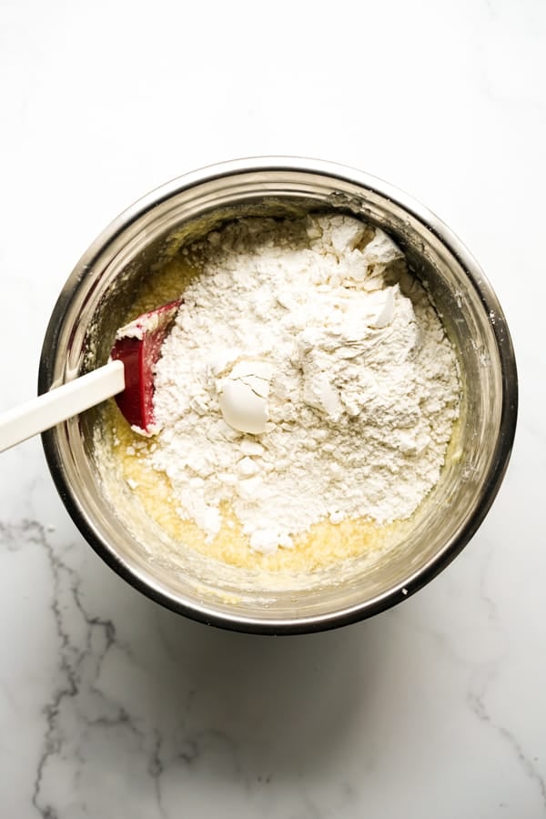 Adding flour to wet mixture in mixing bowl