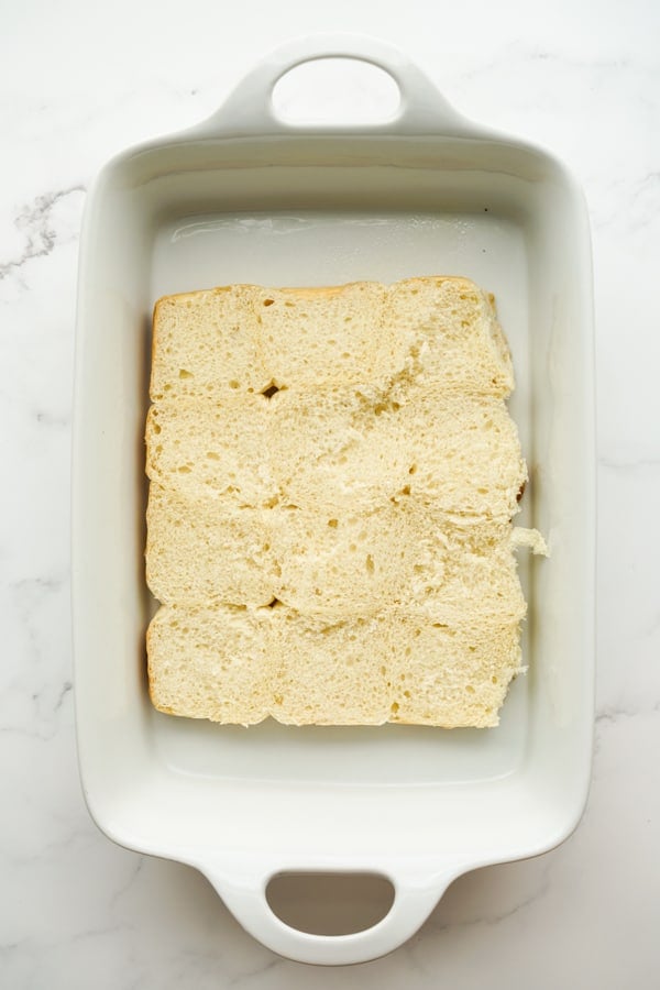 Bottom Hawaiian rolls on a rectangular baking dish