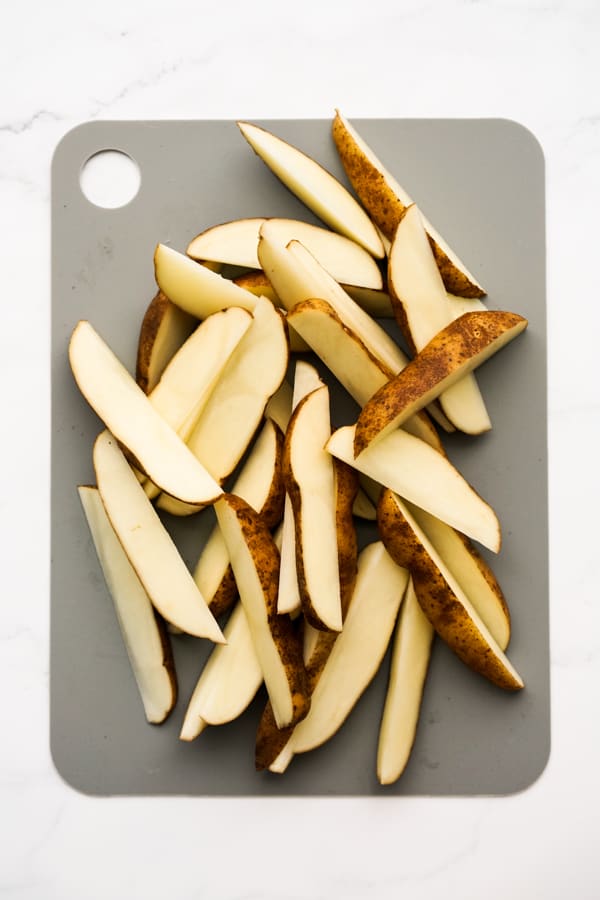 Slices of potato wedges on cutting board