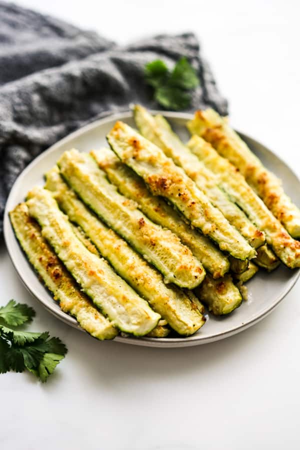 A plate of baked zucchini spears