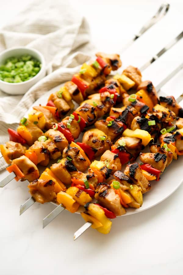 Grilled chicken kebobs, pineapple, bell peppers on sticks 