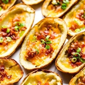 Crispy potato skin topped with bacon, cheese and green onions