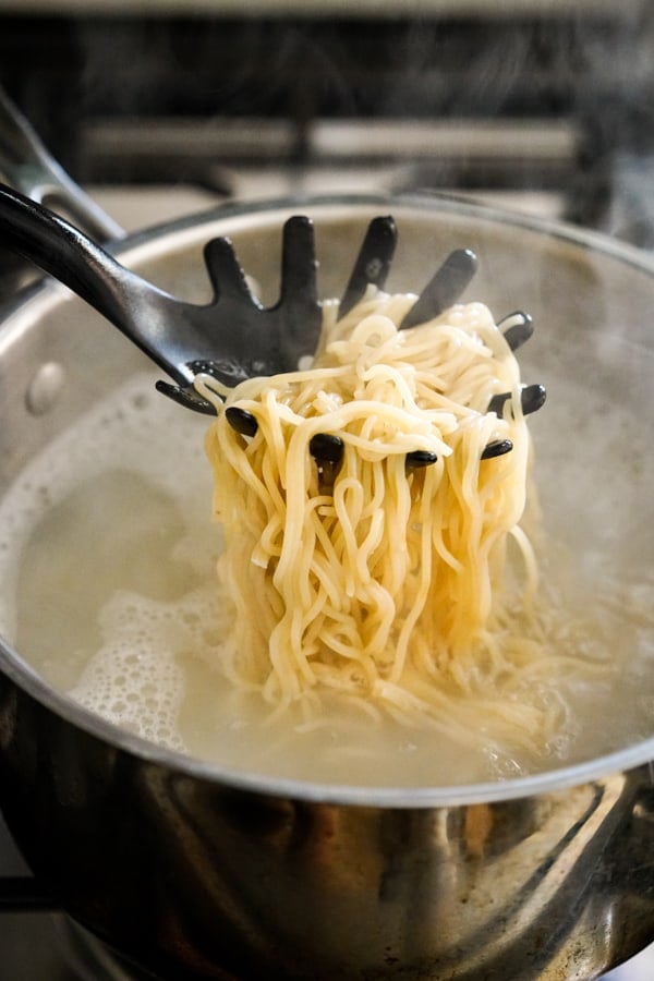 Boiling ramen noodles in a pot of water