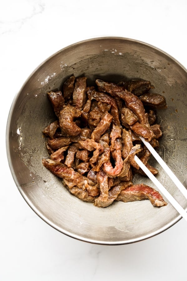 Marinating beef slices in a bowl