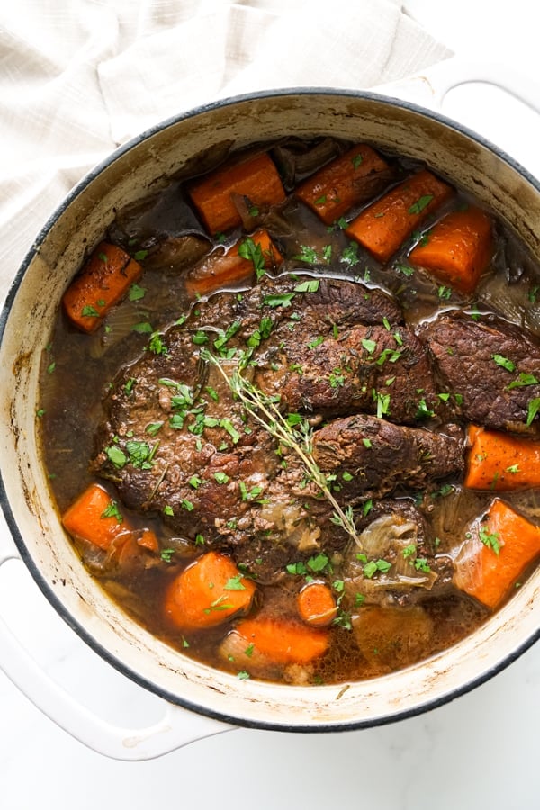 Pot roast and vegetables in a Dutch oven