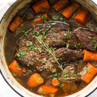 Top down view of Stovetop Pot ROast in a large pot with carrots and juices