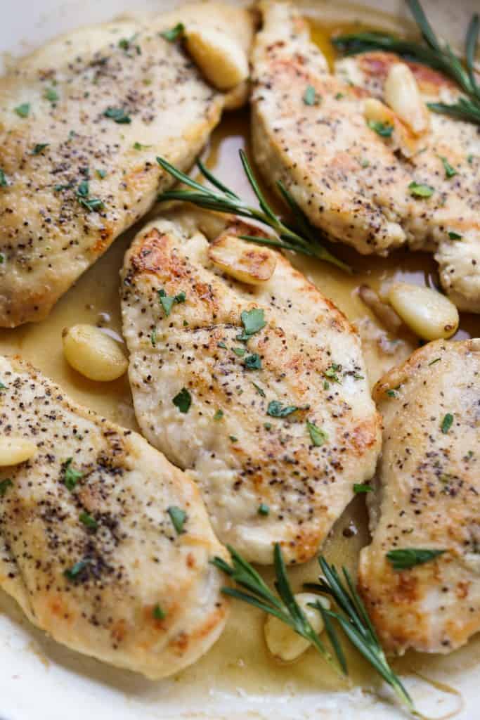 Closeup of a piece of garlic rosemary chicken breast