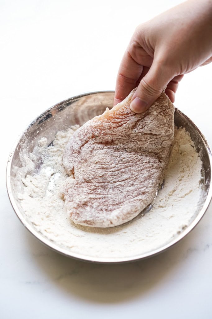 coated chicken cutlet in flour mixture