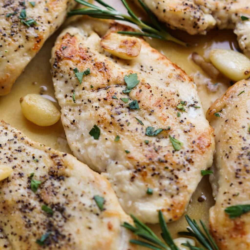 A piece of chicken breast in Rosemary garlic sauce